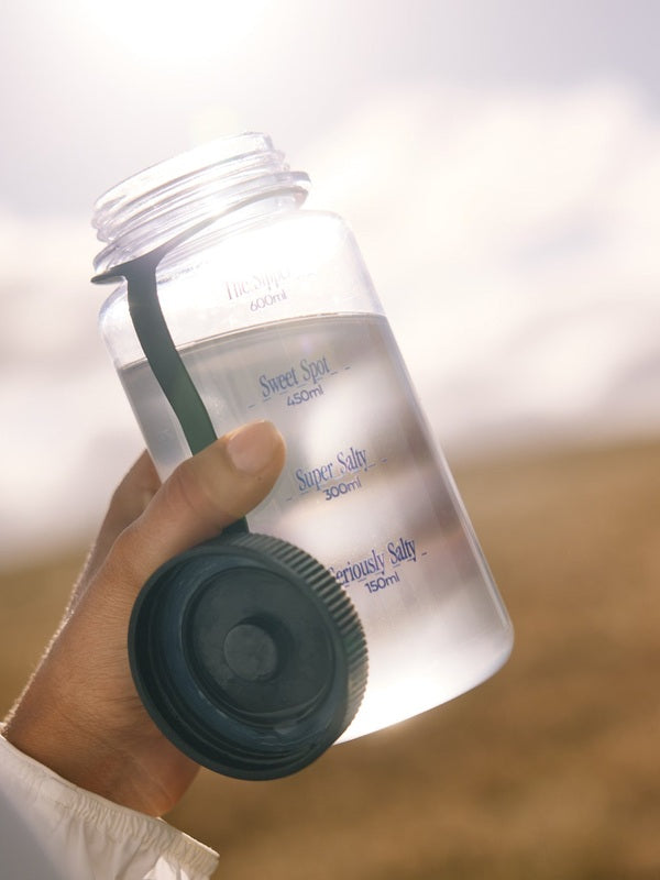 Sodii Everyday Hydration Salts Unflavoured mixed in a reusable water bottle outdoors