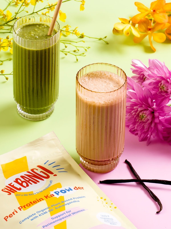 She BANG! Vanilla Peri Protein POWder styled with flowers and prepared drinks