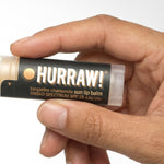 Hand holding Hurraw! Sun Lip Balm SPF15 4.8g