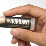 Hand holding Hurraw! Sun Lip Balm SPF15 4.8g
