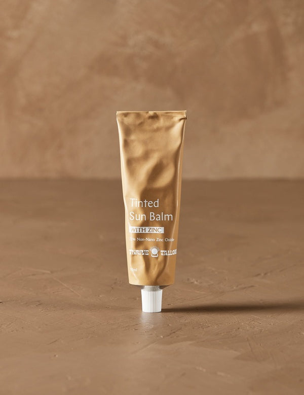 Tinted Sun Balm tube in warm natural light – Thrive Tallow Tinted Sun Balm with Zinc 70ml