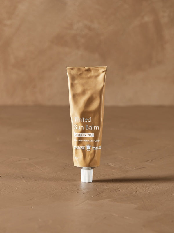 Tinted Sun Balm tube in warm natural light – Thrive Tallow Tinted Sun Balm with Zinc 70ml