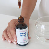 Fulvic Humic Concentrate dropper being used beside a glass of water