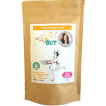 A brown resealable pouch labeled Supercharged Food Golden Gut 100g shows a chef-hatted woman holding a tray and a circular badge with her photo. This turmeric superfood blend is designed to support digestive wellness.