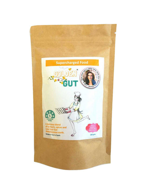 A brown resealable pouch labeled Supercharged Food Golden Gut 100g shows a chef-hatted woman holding a tray and a circular badge with her photo. This turmeric superfood blend is designed to support digestive wellness.