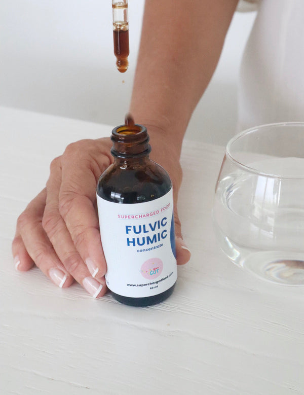 Fulvic Humic Concentrate dropper being used beside a glass of water