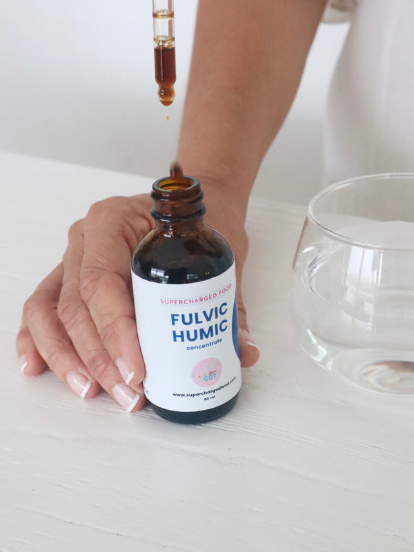 Fulvic Humic Concentrate dropper being used beside a glass of water
