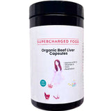 A black container of Supercharged Food Love Your Gut Organic Beef Liver Capsules (120 caps), featuring a label with a woman, a cat, and details like grass-fed, freeze-dried, B12, vitamin A, and made in Australia.