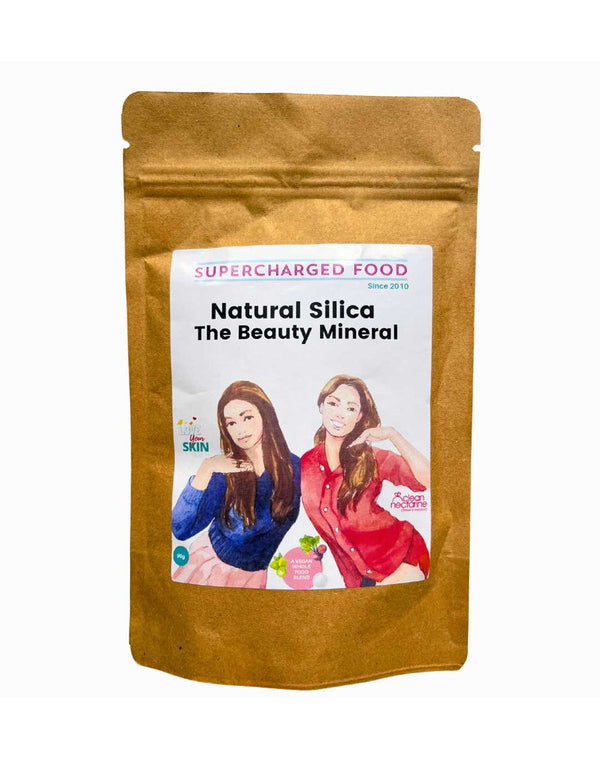 A brown resealable pouch labeled Supercharged Food Natural Silica The Beauty Mineral Vegan Collagen Support 90g, with two women and icons, promotes hair, skin, and nail health as a vegan collagen supplement.