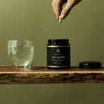 Ashwagandha capsules beside water in a daily wellness ritual
