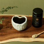 SuperFeast JING beside a prepared tonic in a daily ritual