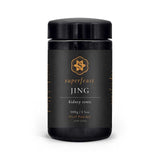 A black jar of Superfeast Jing, 100g / 3.5oz oral powder, with gold and white text and a gold floral logo, features energy herbs formulated to restore vital energy and support stress relief.