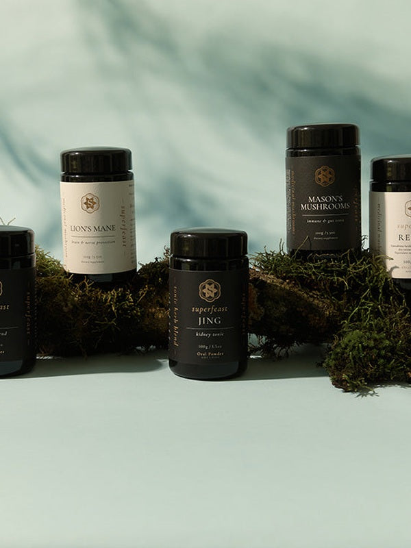 SuperFeast tonic range displayed with forest ingredients