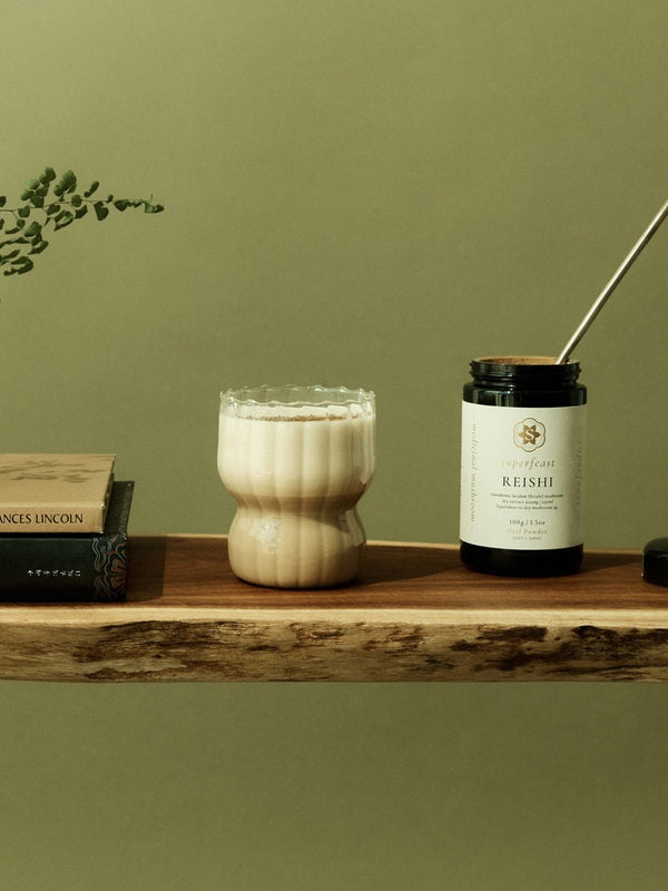 SuperFeast Reishi beside a creamy tonic in a daily ritual