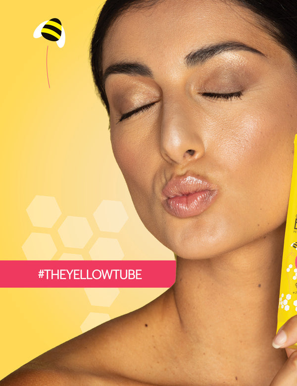 Woman holding Suvana Organic Paw Paw and Honey Lip Balm