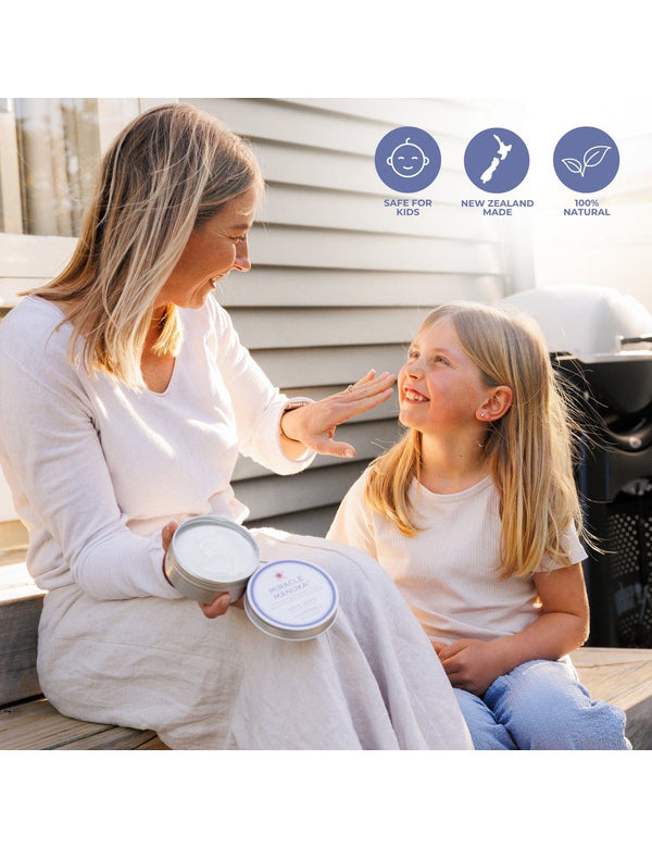 Mother and daughter applying Sven's Island Miracle Manuka Daily Defence Cream outdoors, with Love Your Skin, New Zealand Made and 100% Natural callouts.