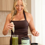 Woman blending a greens drink with Switch Nutrition Sage Green Whiz Stick