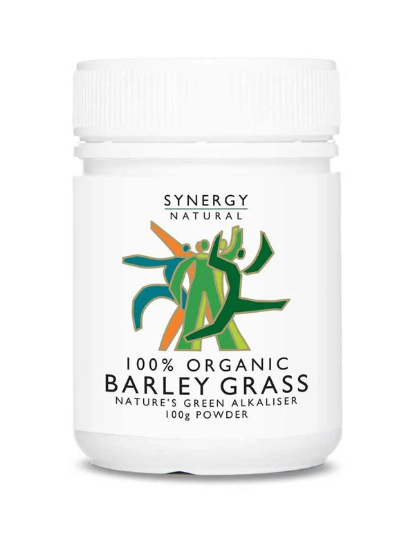 White Synergy Natural Organic Barley Grass powder bottle with a ribbed white screw lid. The front label shows green and orange stylised figures above black 'BARLEY GRASS' lettering.