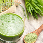 Prepared green barley grass drink with fresh grass and powder