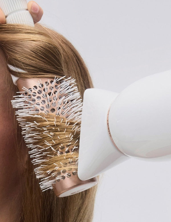 T3 Featherweight StyleMax Hair Dryer in use with brush