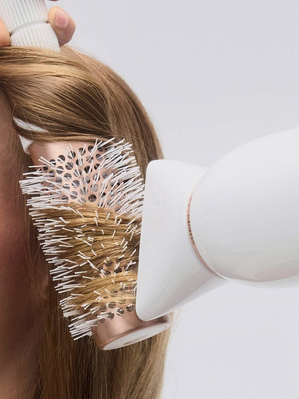 T3 Featherweight StyleMax Hair Dryer in use with brush