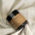 The Age Hack NAD powder styled on soft fabric