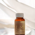 The Age Hack NMN bottle styled on soft white fabric