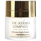 The Jojoba Company Ultimate Night Cream in a frosted jar with a broad, reflective gold top and black lettering.