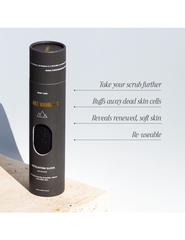 Tall black cylindrical packaging for the Three Warriors Exfoliating Glove, with a window showing its textured surface and text about exfoliation and reuse.