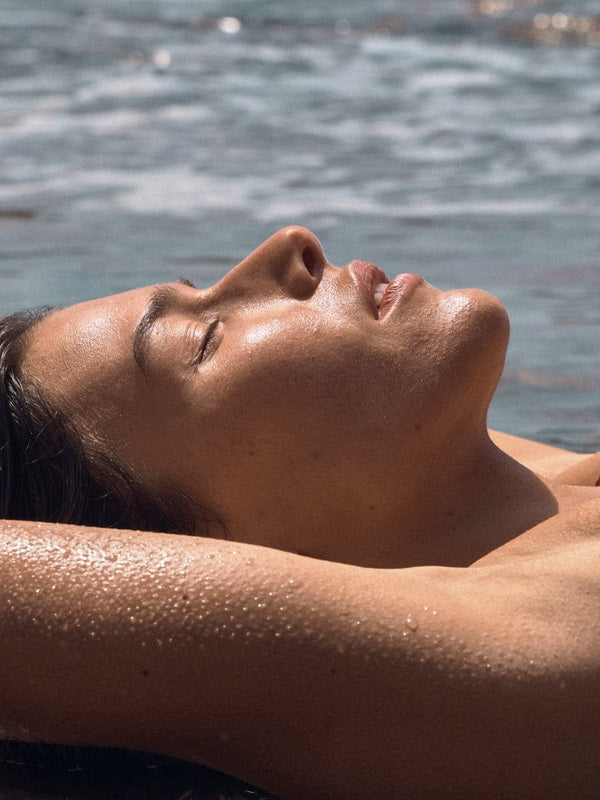 Woman relaxing poolside with a sun kissed glow