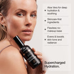 Woman holding Face Tan Aqua Mist with hydration benefits