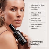Woman holding Face Tan Aqua Mist with hydration benefits