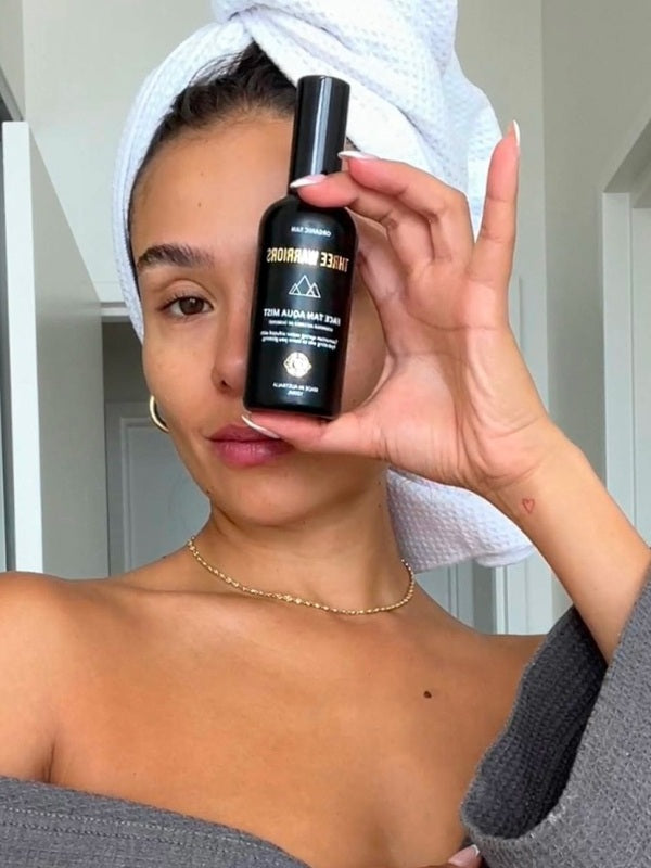 Woman holding Three Warriors Face Tan Aqua Mist