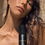 Woman holding Three Warriors Self Tan Mousse