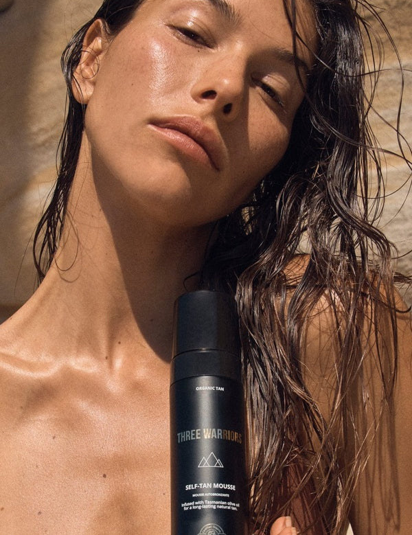 Woman holding Three Warriors Self Tan Mousse