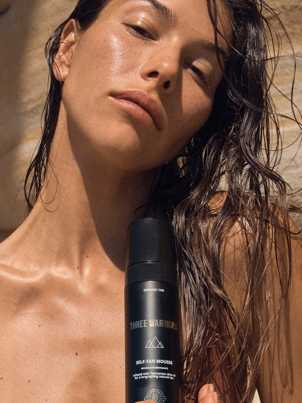 Woman holding Three Warriors Self Tan Mousse