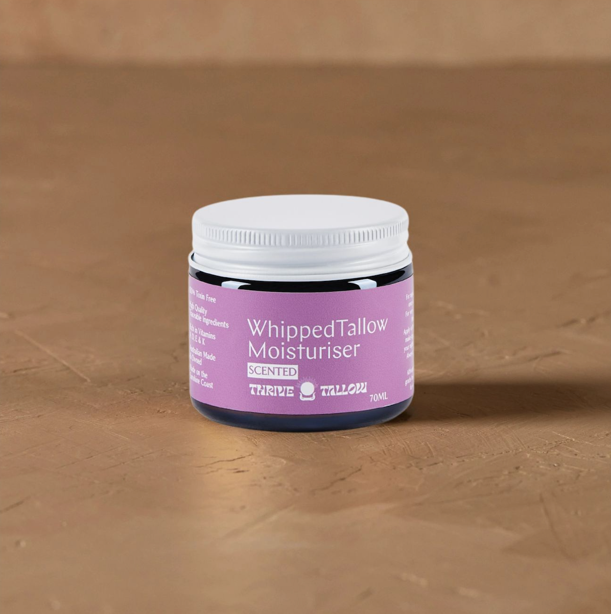 Thrive Tallow Ylang Ylang and Vanilla Whipped Moisturiser 70ml in warm light