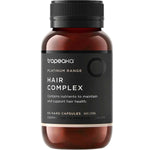 A brown bottle labeled Tropeaka Hair Complex 60 Caps with a black lid. The label notes it provides nutrients to support and maintain hair health, and contains 60 hard capsules by Tropeaka.