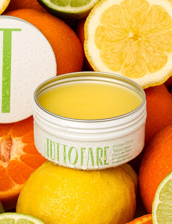 Tuttofare Sicilian Citrus Tallow Balm among fresh citrus fruit