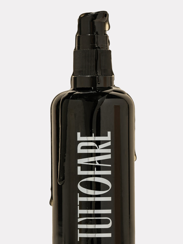 Tuttofare Cleansing Oil black bottle with oil dripping down the side