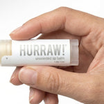 Hand holding Hurraw! Unscented Lip Balm 4.8g