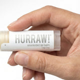 Hand holding Hurraw! Unscented Lip Balm 4.8g