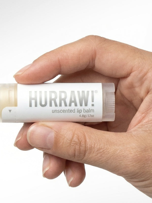 Hand holding Hurraw! Unscented Lip Balm 4.8g