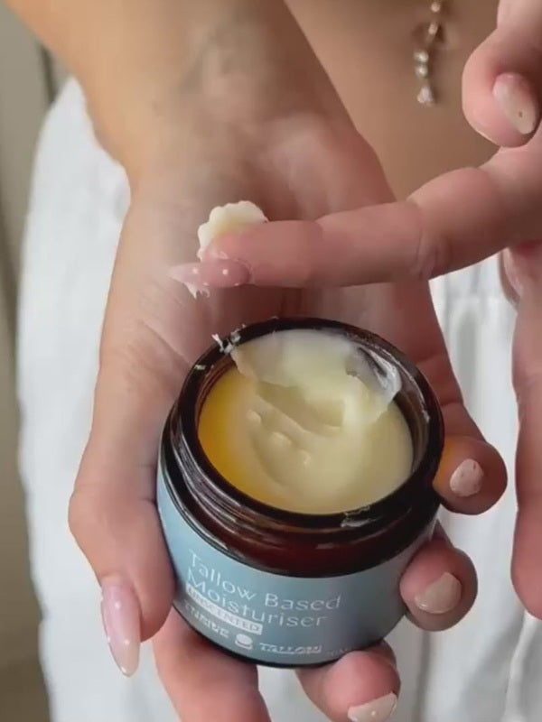 Hand taking Unscented Tallow Based Moisturiser from the jar – Thrive Tallow Based Moisturiser Unscented 70ml