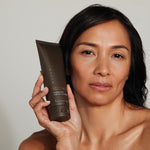 Woman holding Metamorphosis Recovery Hydrating Cream Cleanser