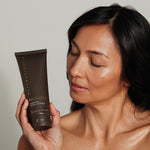 Woman looking at Metamorphosis Recovery Hydrating Cream Cleanser