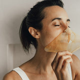 Model wearing Vanessa Megan Gold and Lime Caviar Sheet Mask