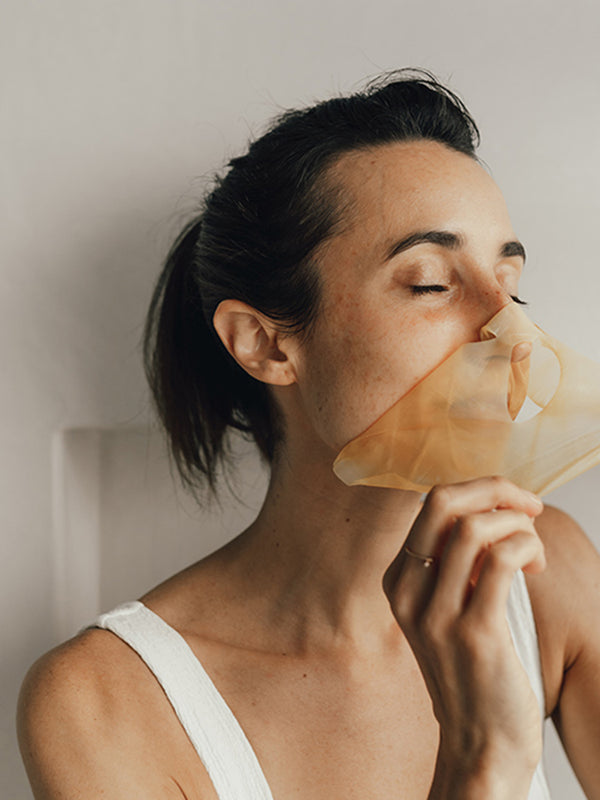 Model wearing Vanessa Megan Gold and Lime Caviar Sheet Mask