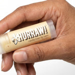 Hand holding Hurraw! Organic Lip Balm - Vanilla Bean 4.8g