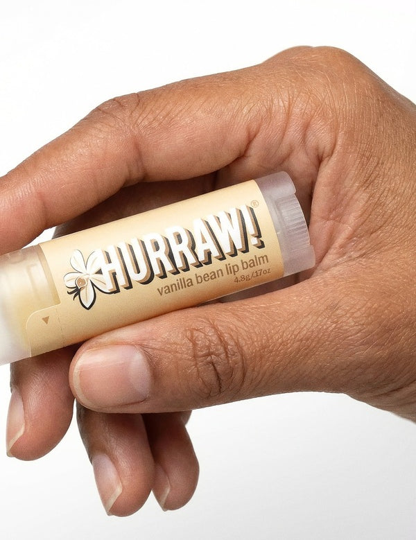 Hand holding Hurraw! Organic Lip Balm - Vanilla Bean 4.8g